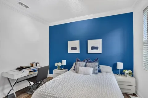 a bedroom with a bed and a desk