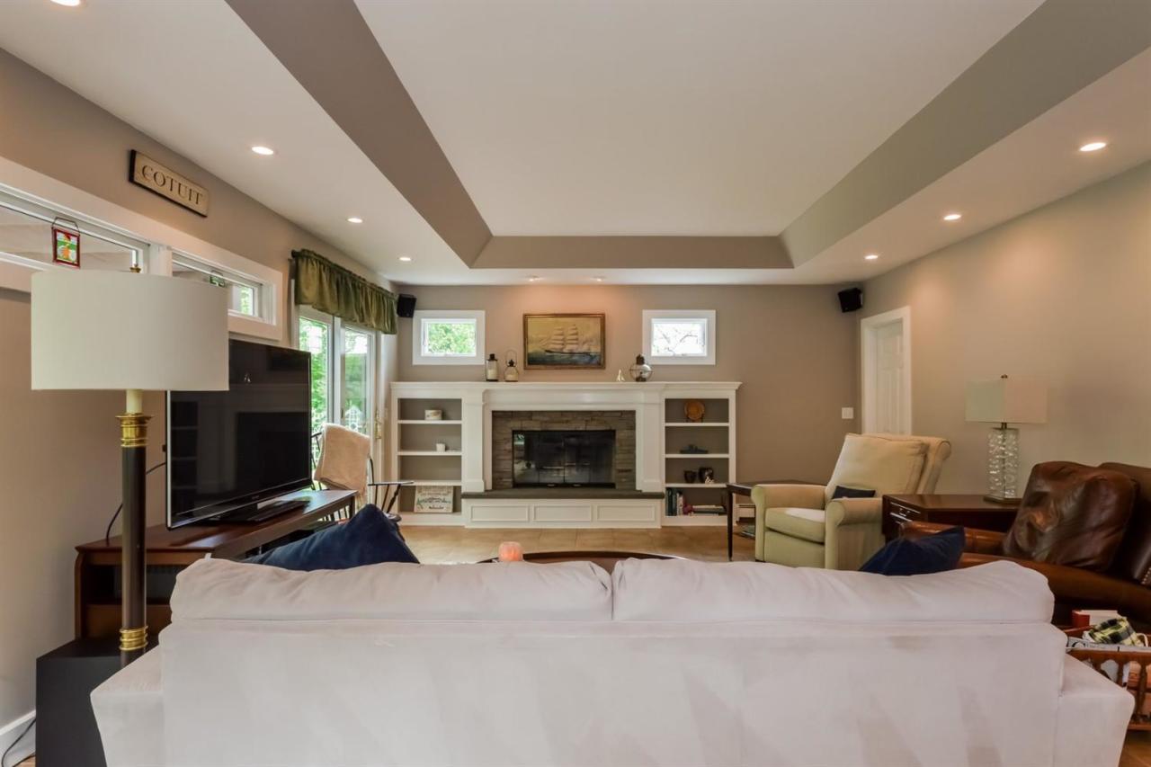 43 Poponessett Road Cotuit, MA 02635 - Photo 11 of 31 a living room with furniture and a fireplace