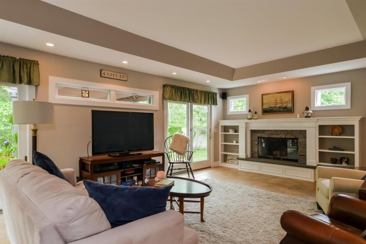 43 Poponessett Road Cotuit, MA 02635 - Photo 12 of 31 a living room with furniture and a fireplace