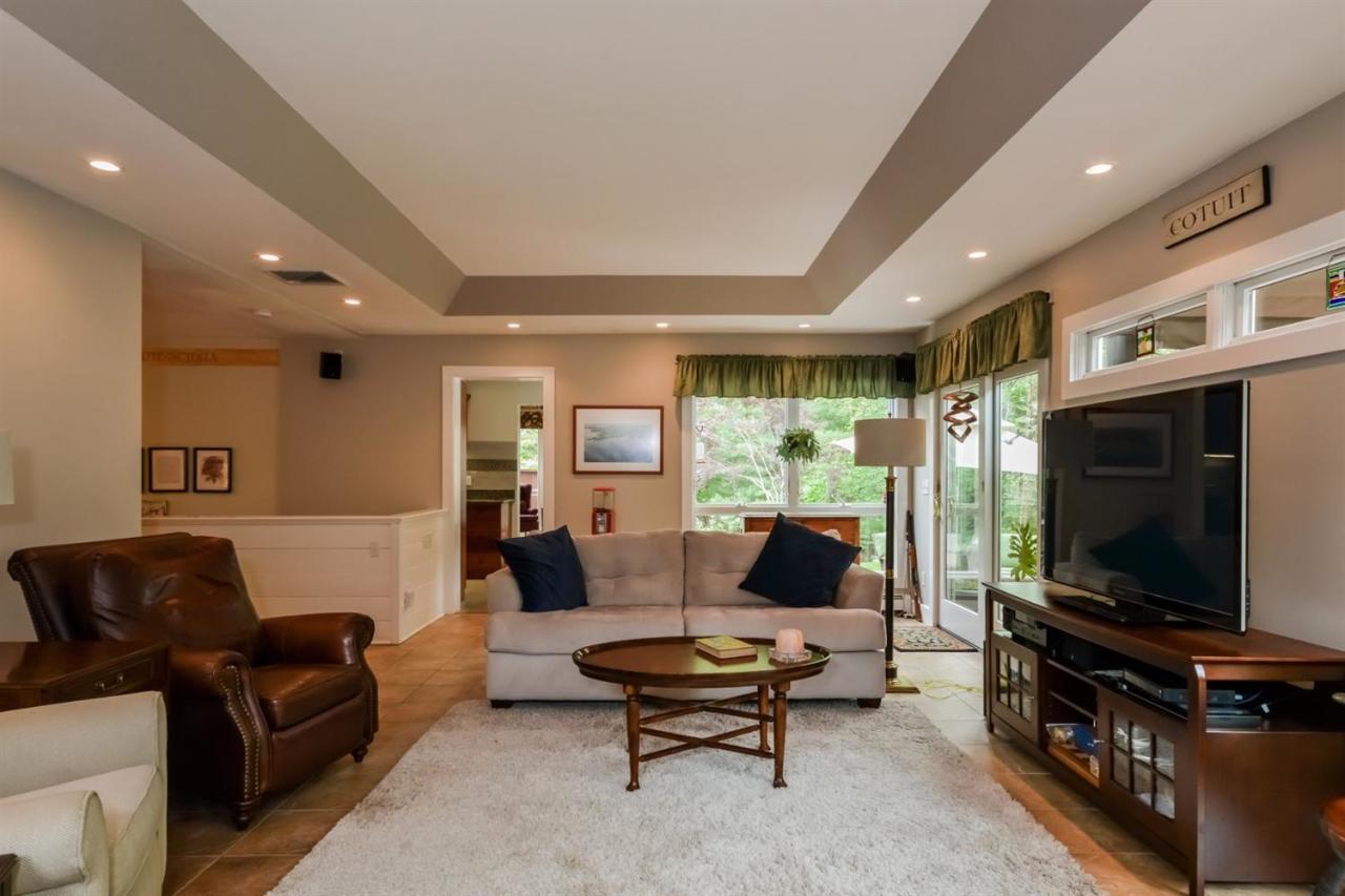 43 Poponessett Road Cotuit, MA 02635 - Photo 15 of 31 a living room with furniture and a flat screen tv