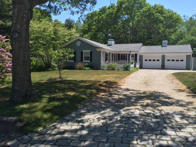 43 Poponessett Road Cotuit, MA 02635 - Photo 2 of 31 a front view of a house with a yard