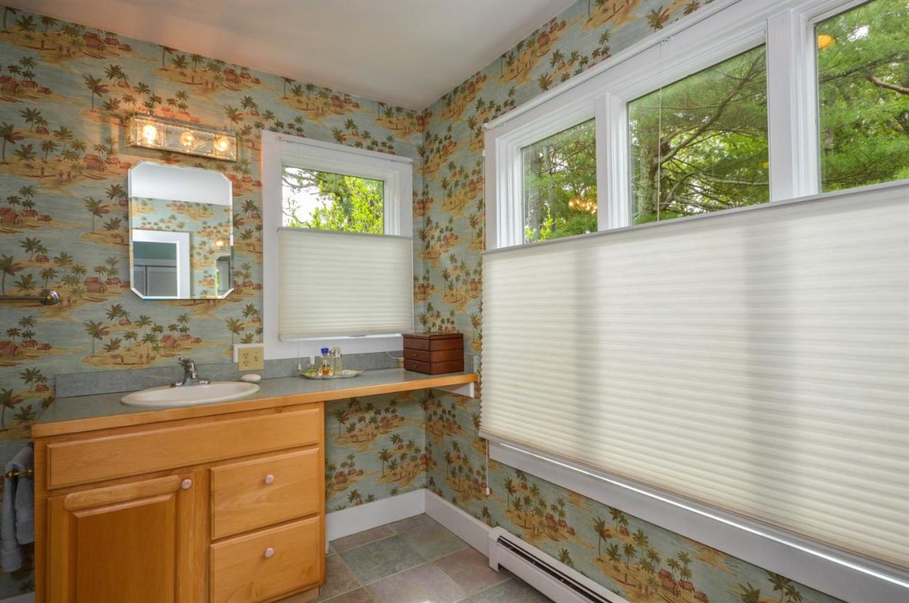 43 Poponessett Road Cotuit, MA 02635 - Photo 21 of 31 a bathroom with a sink a mirror and a window