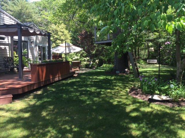 43 Poponessett Road Cotuit, MA 02635 - Photo 24 of 31 a backyard of a house with lots of green space