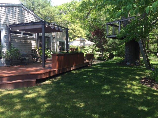 43 Poponessett Road Cotuit, MA 02635 - Photo 25 of 31 a backyard of a house with yard and outdoor seating