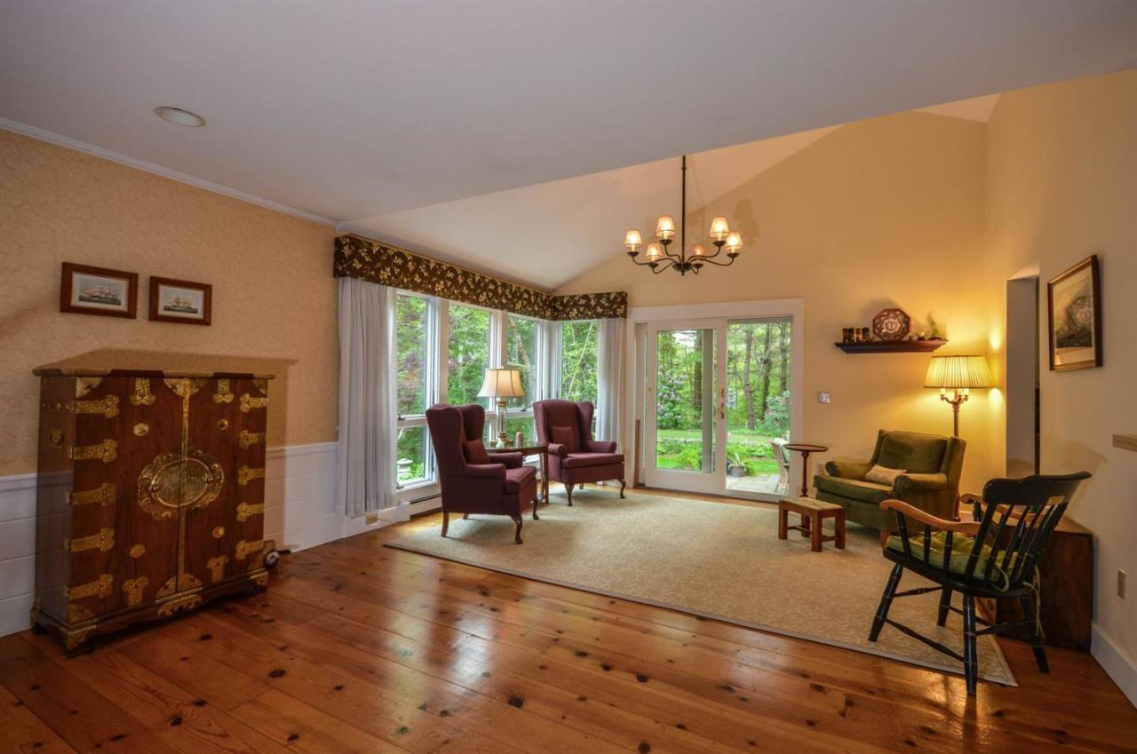 43 Poponessett Road Cotuit, MA 02635 - Photo 4 of 31 a living room with furniture large window and flat screen tv