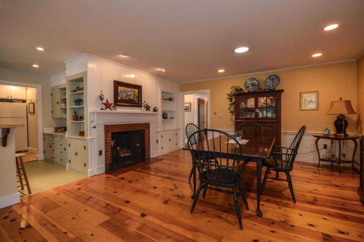 43 Poponessett Road Cotuit, MA 02635 - Photo 7 of 31 a view of a dining room with furniture and wooden floor