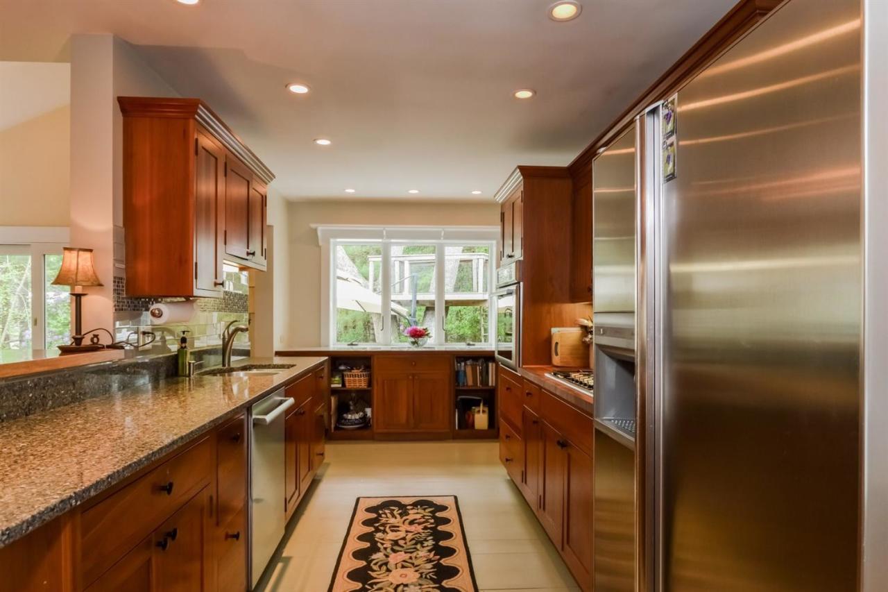 43 Poponessett Road Cotuit, MA 02635 - Photo 9 of 31 a kitchen with granite countertop a refrigerator and a sink