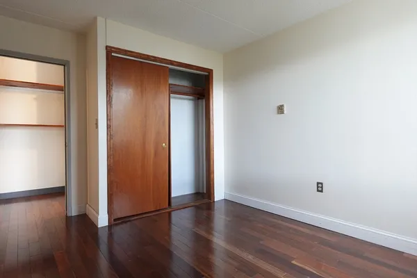 a bathroom with a toilet sink vanity and mirror