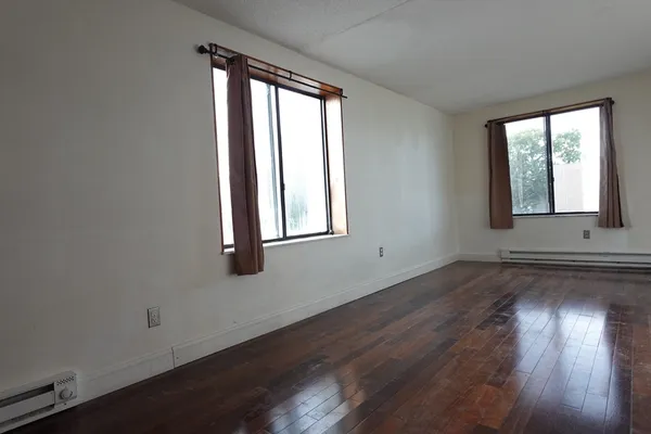 a view of hallway with wooden floor