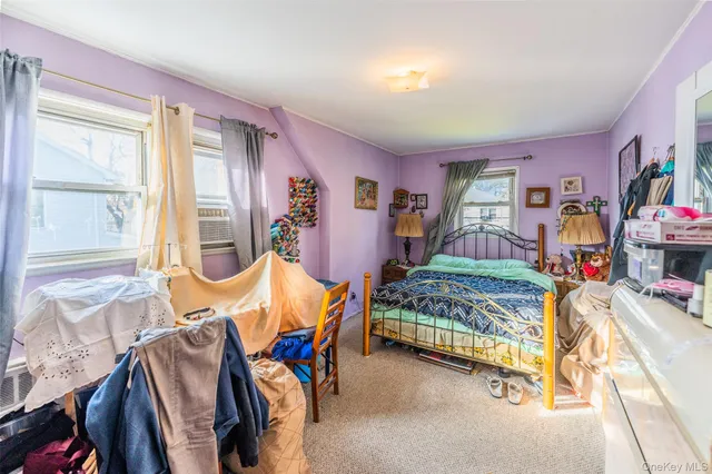 a bedroom with two beds and a window