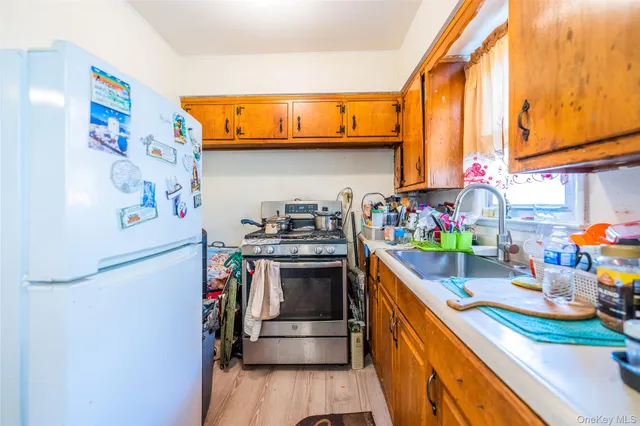 a kitchen with stainless steel appliances granite countertop a lot of cabinets and wooden floor