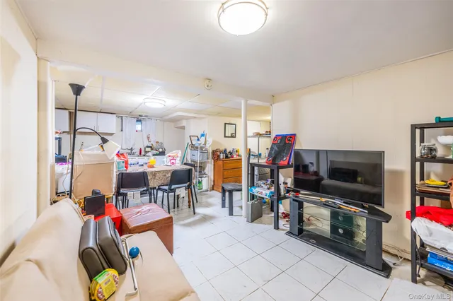 a living room with lots of furniture and clutter