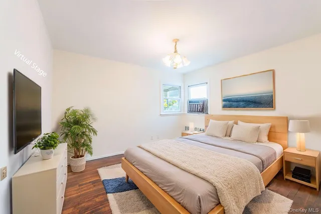 a bedroom with a bed and a potted plant