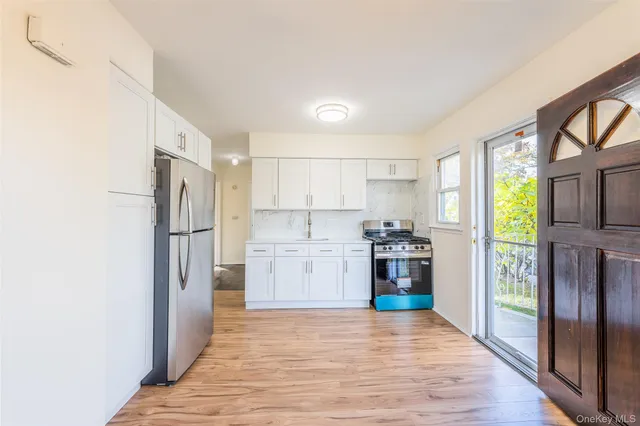 a kitchen with stainless steel appliances granite countertop a refrigerator and a stove top oven
