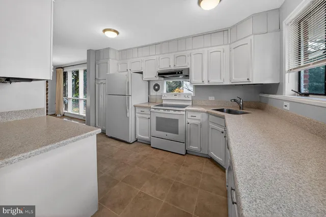 a kitchen with a sink a stove and refrigerator