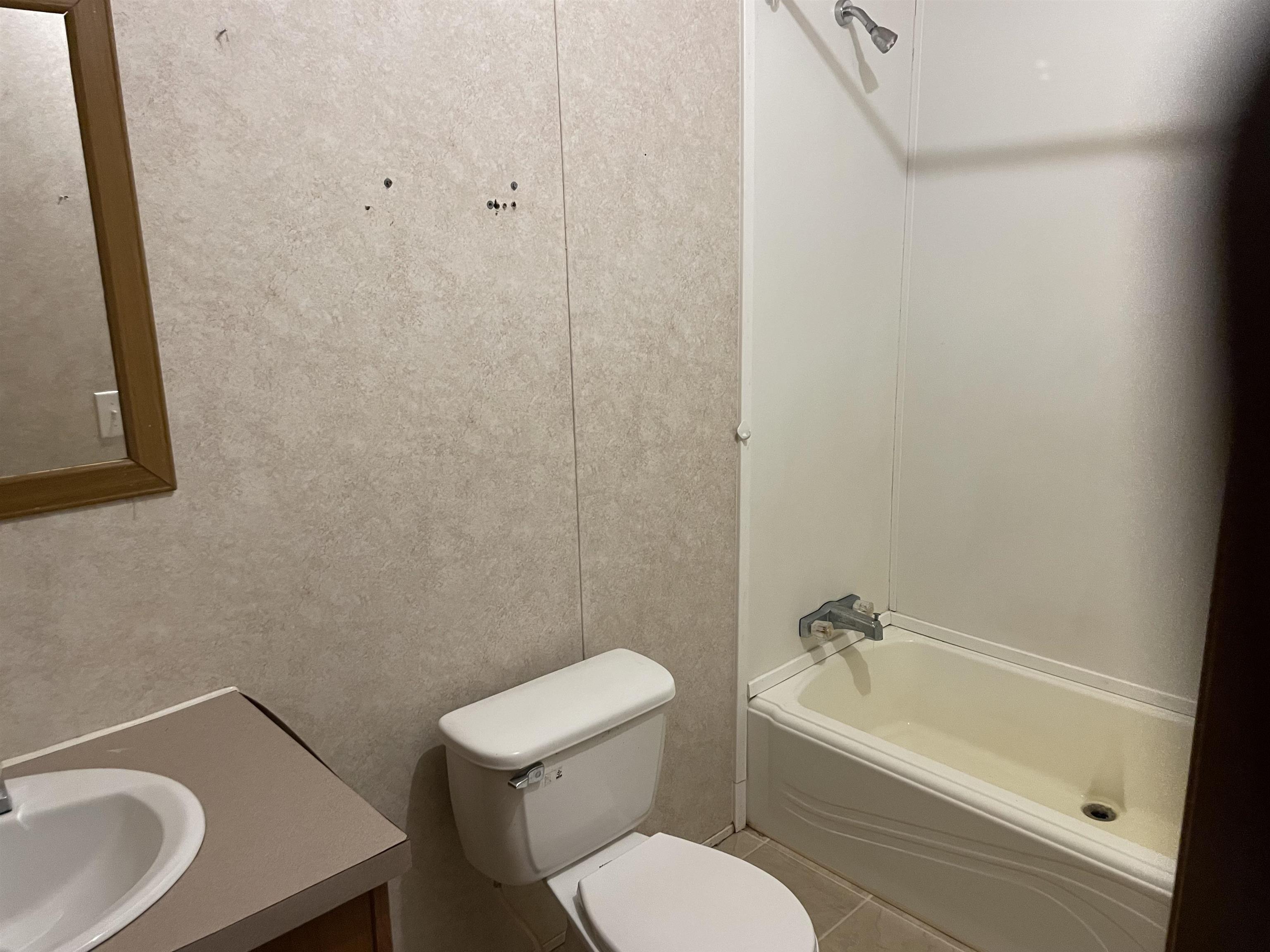 709 Robertson Road Mason, TN 38049 - Photo 12 of 16 a white toilet sitting next to a bath tub