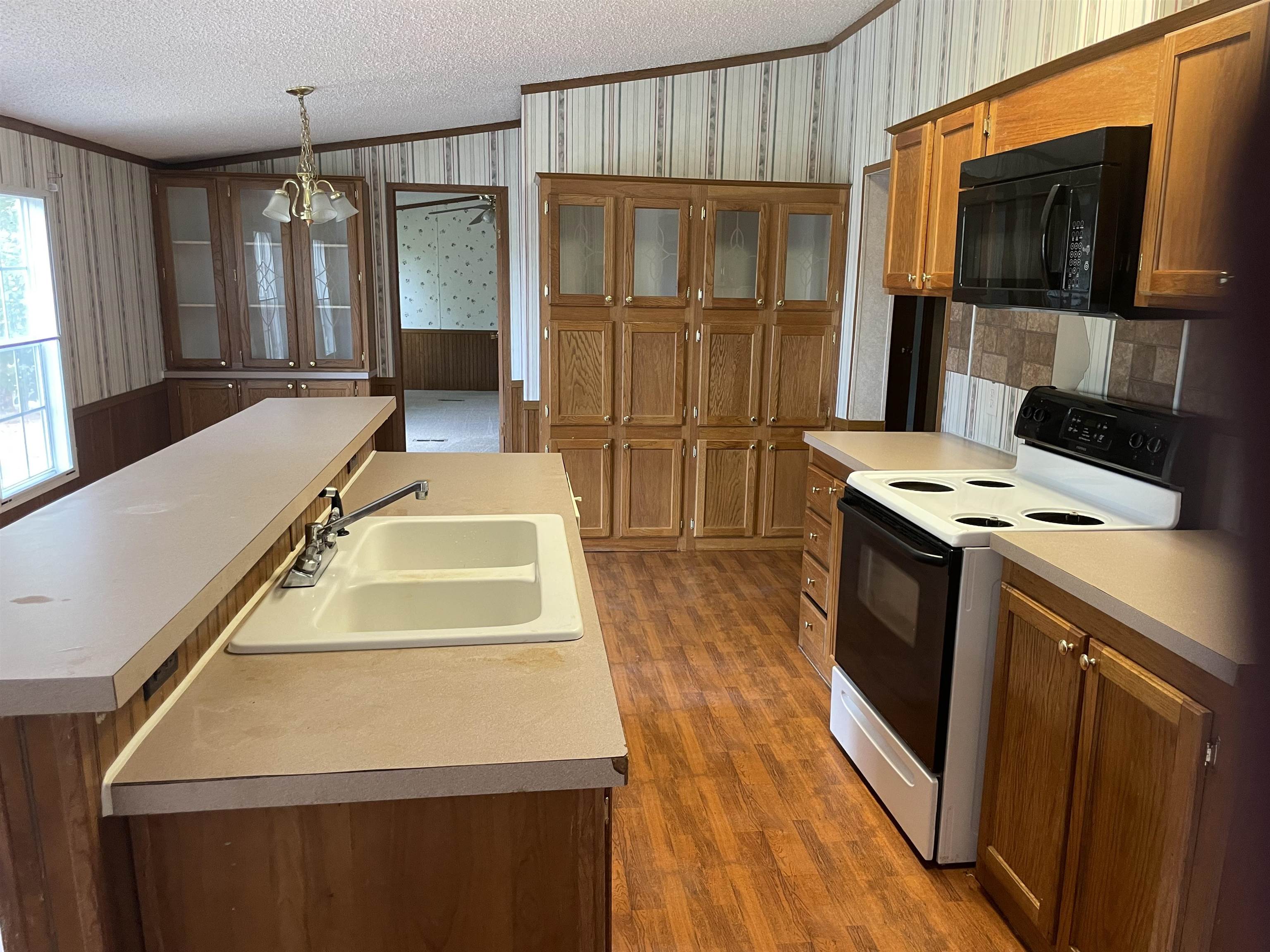 709 Robertson Road Mason, TN 38049 - Photo 6 of 16 a kitchen with kitchen island a counter top space a sink stainless steel appliances and cabinets