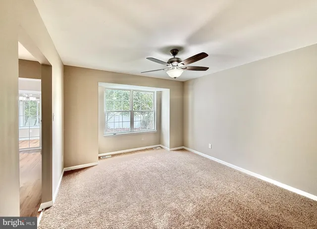 a view of a kitchen with microwave and windows