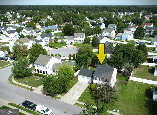 an aerial view of residential houses with outdoor space and street view