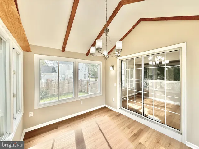 a view of an empty room and a ceiling fan