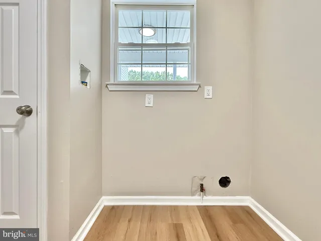 a bathroom with a sink toilet a large mirror and a window