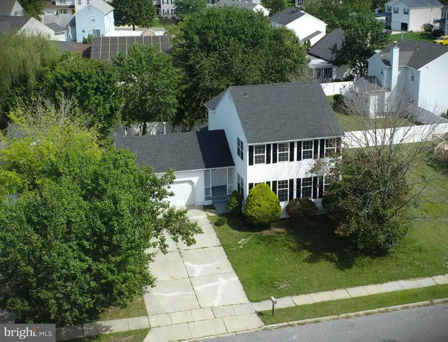 an aerial view of a house with swimming pool and garden