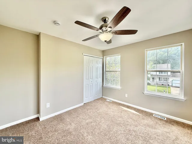a front view of a house with a garden and plants