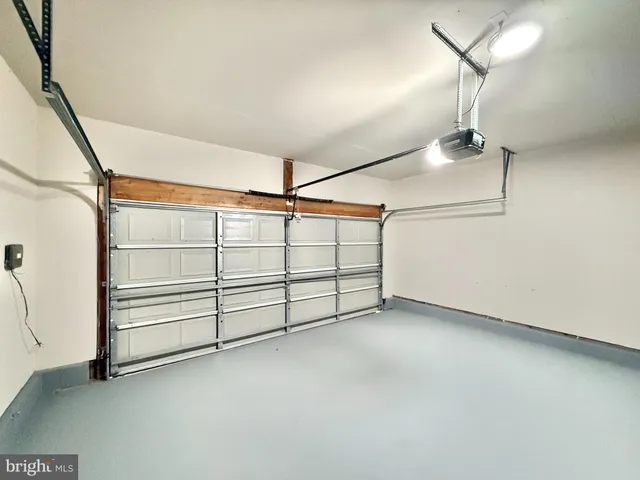 an empty room with windows and ceiling fan