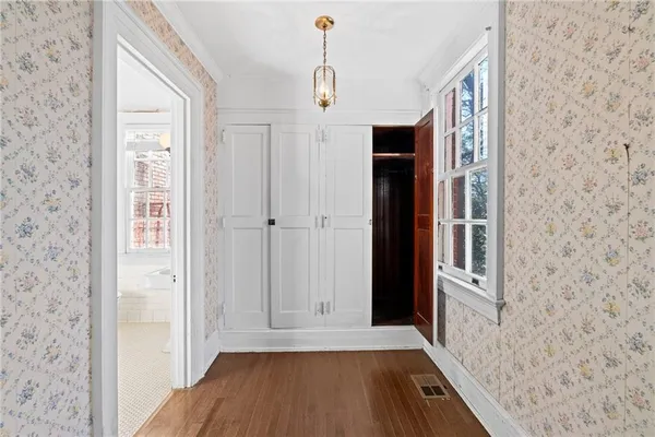 a kitchen with stainless steel appliances granite countertop a stove top oven a refrigerator and a sink with wooden floor