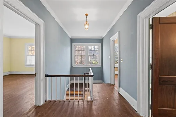 a view of a entrance and room with wooden floor