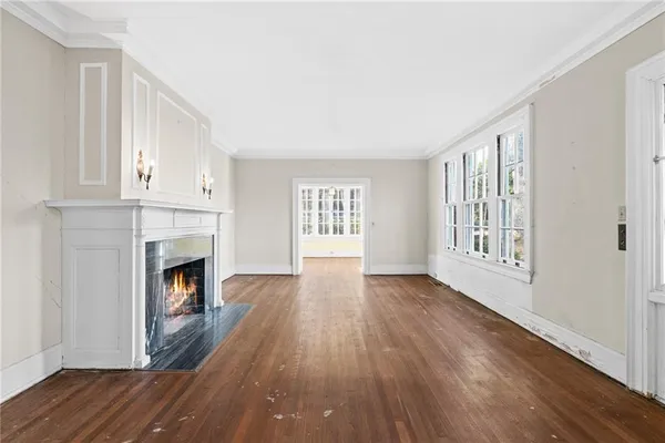 a view of an entryway with wooden floor and a livingroom