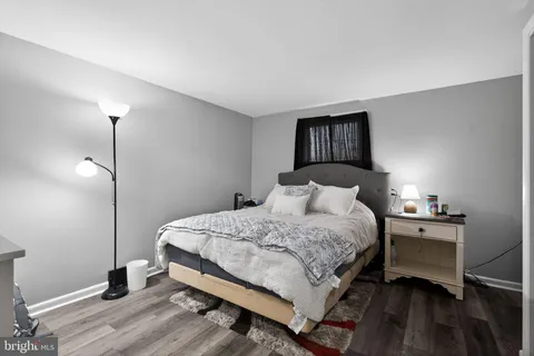 a bedroom with a bed and a lamp on table