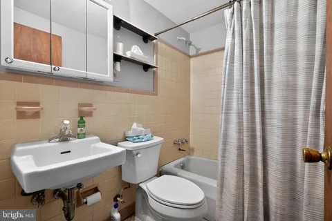 a bathroom with a sink a mirror a toilet and a shower