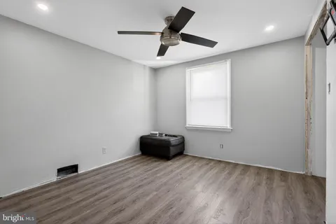 a room with wooden floor and windows