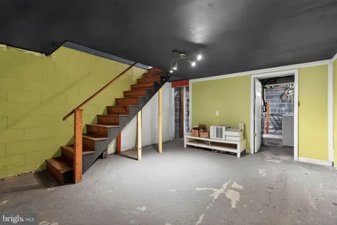 a view of room with stairs and furniture