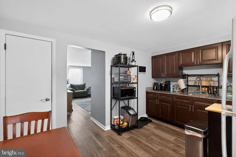 a kitchen with a refrigerator and a stove