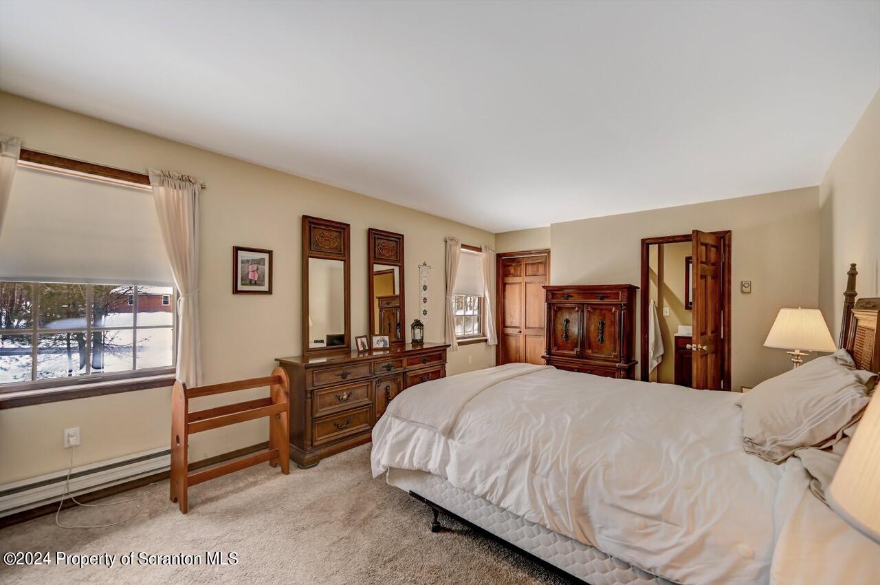 820 Forest Road Lake Ariel, PA 18436 - Photo 32 of 58 a bedroom with a large bed and a large window