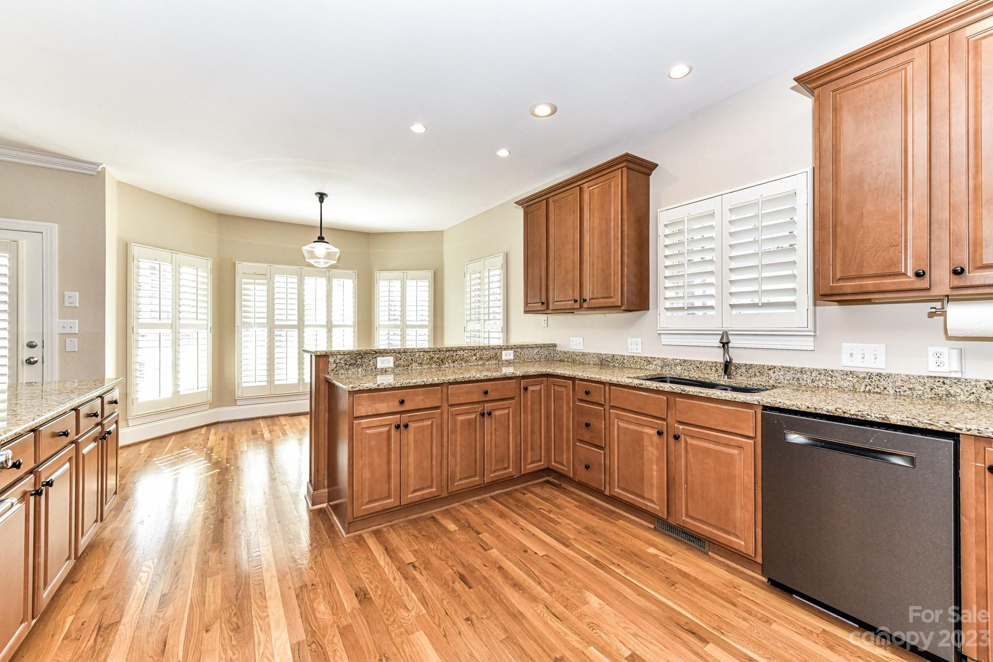 151 Maple View Drive Troutman, NC 28166 - Photo 11 of 43 a large kitchen with stainless steel appliances granite countertop a stove a sink dishwasher and a large refrigerator with wooden floor