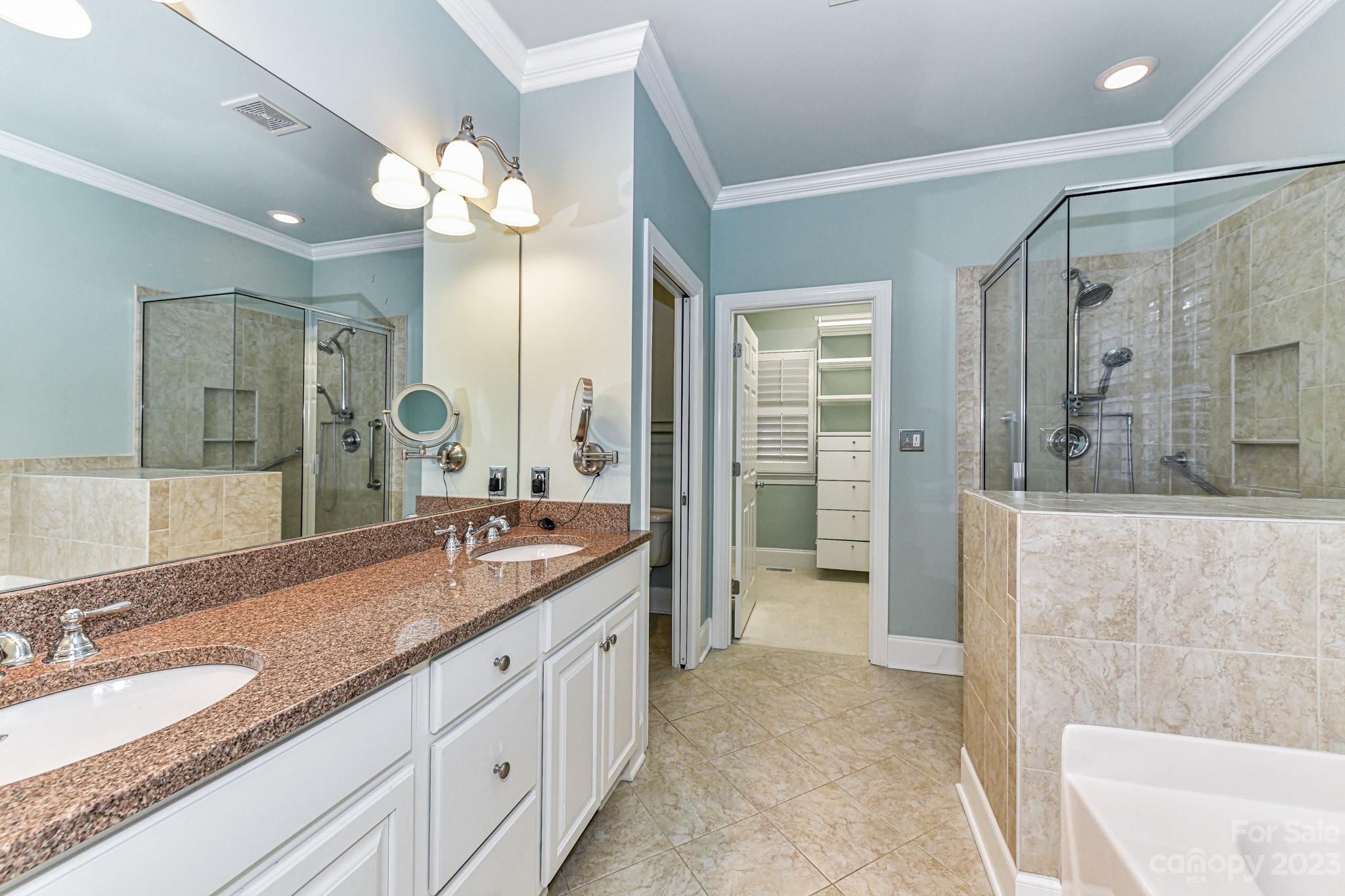 151 Maple View Drive Troutman, NC 28166 - Photo 17 of 43 a spacious bathroom with a granite countertop sink mirror and shower