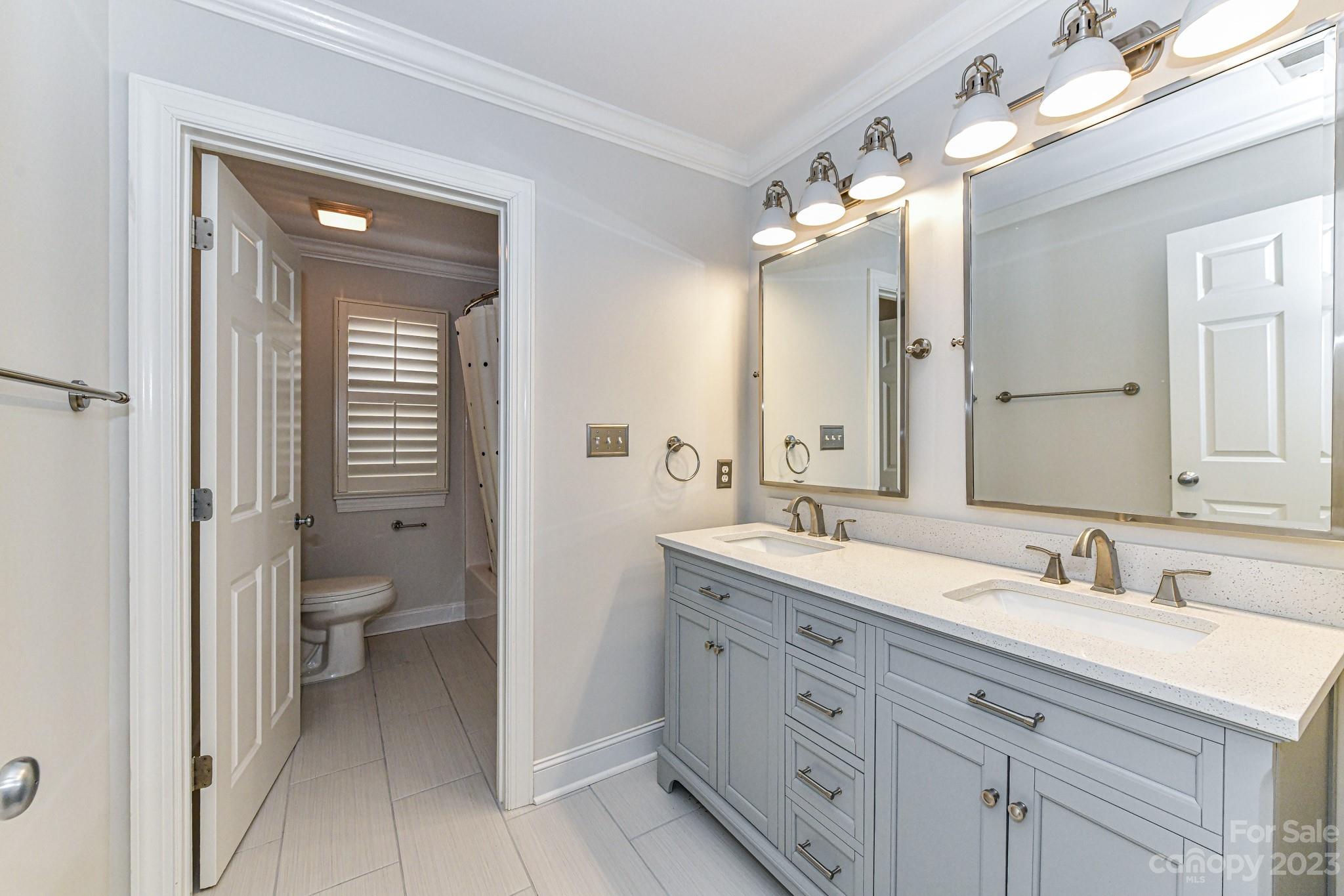 151 Maple View Drive Troutman, NC 28166 - Photo 24 of 43 a bathroom with a double vanity sink and a mirror