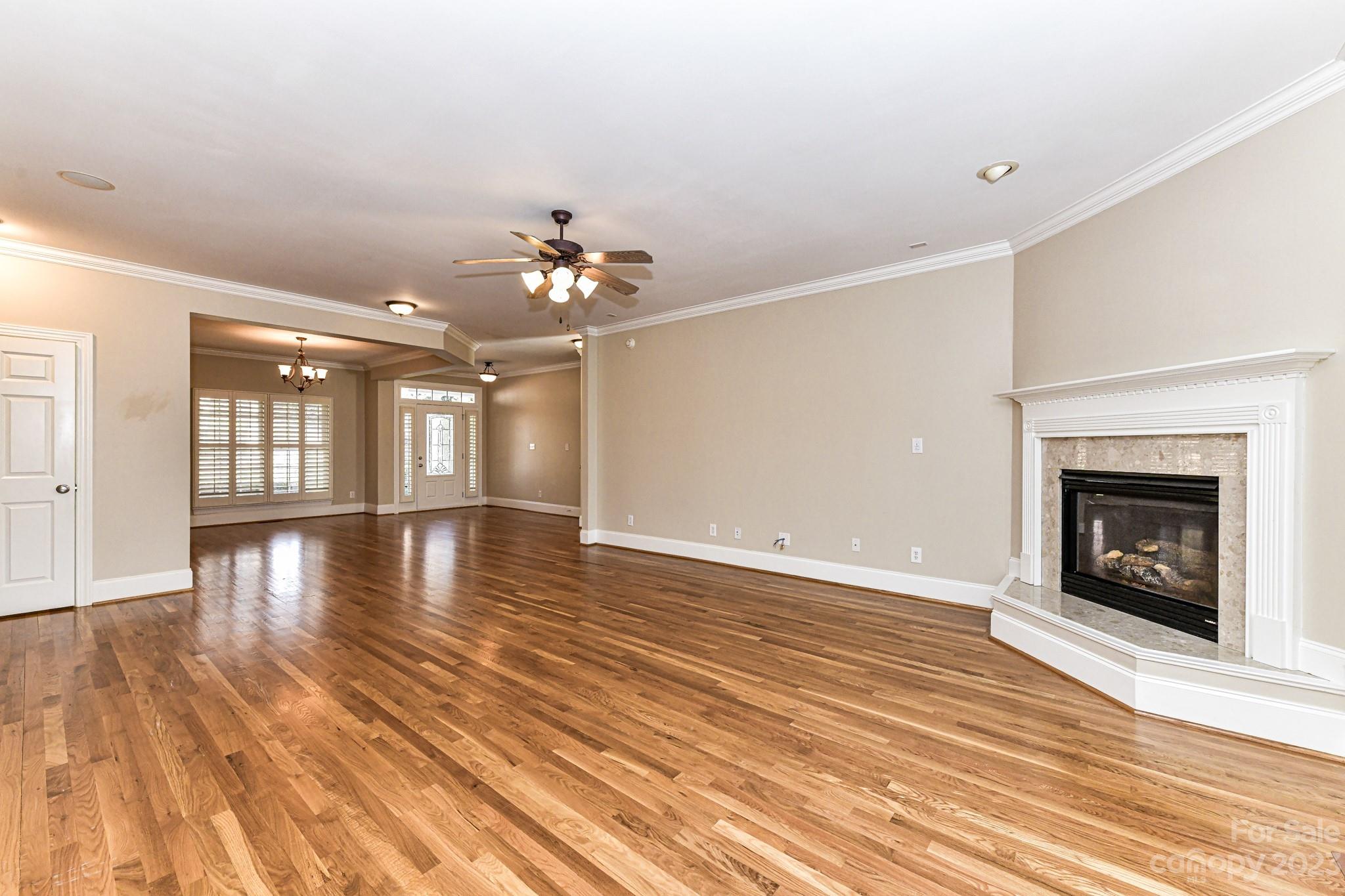 151 Maple View Drive Troutman, NC 28166 - Photo 8 of 43 a view of an empty room with wooden floor and a fireplace