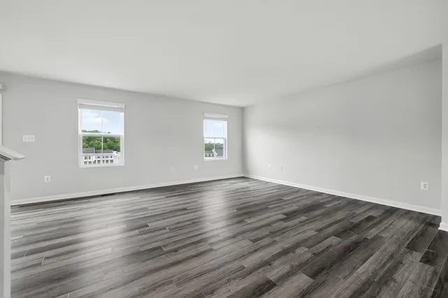a view of a hallway with wooden floor and entryway
