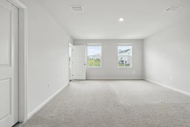 a bedroom with a large bed and potted plant