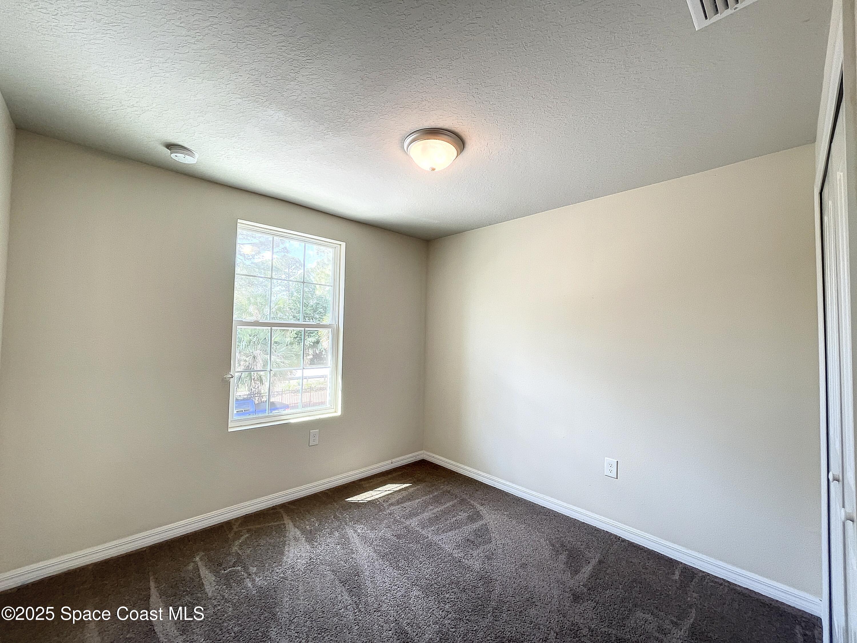 3737 Chambers Lane, Unit 8 Cocoa, FL 32926 - Photo 18 of 24 an empty room with a window