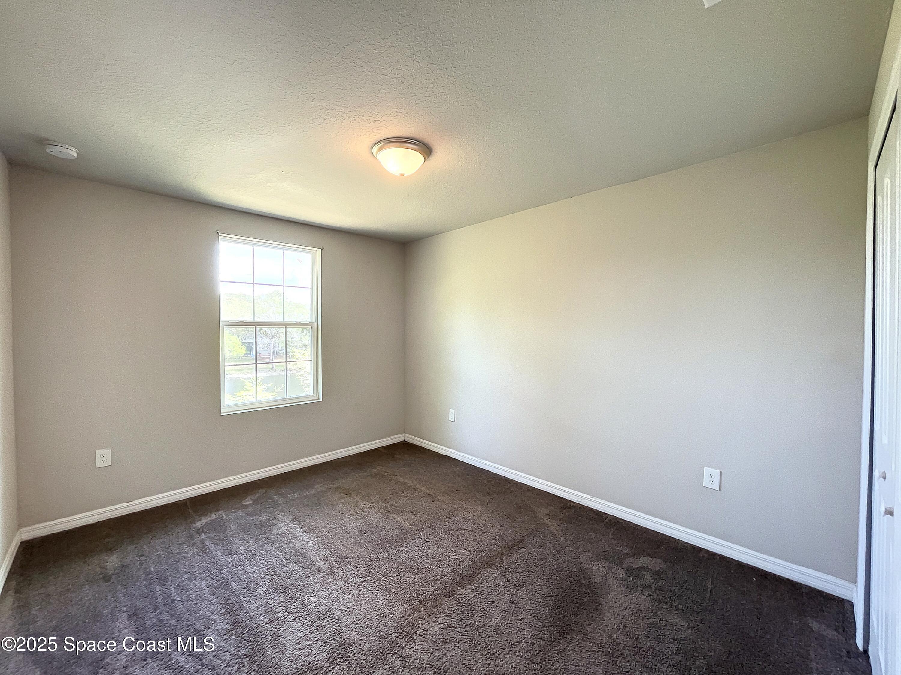 3737 Chambers Lane, Unit 8 Cocoa, FL 32926 - Photo 20 of 24 an empty room with a window