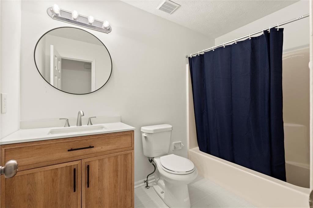 5984 Brookside Court Southeast Mableton, GA 30126 - Photo 15 of 21 a bathroom with a toilet a sink and a mirror