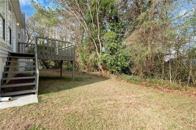 a view of a yard with wooden fence