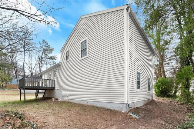 a view of a house with a yard and wooden fence
