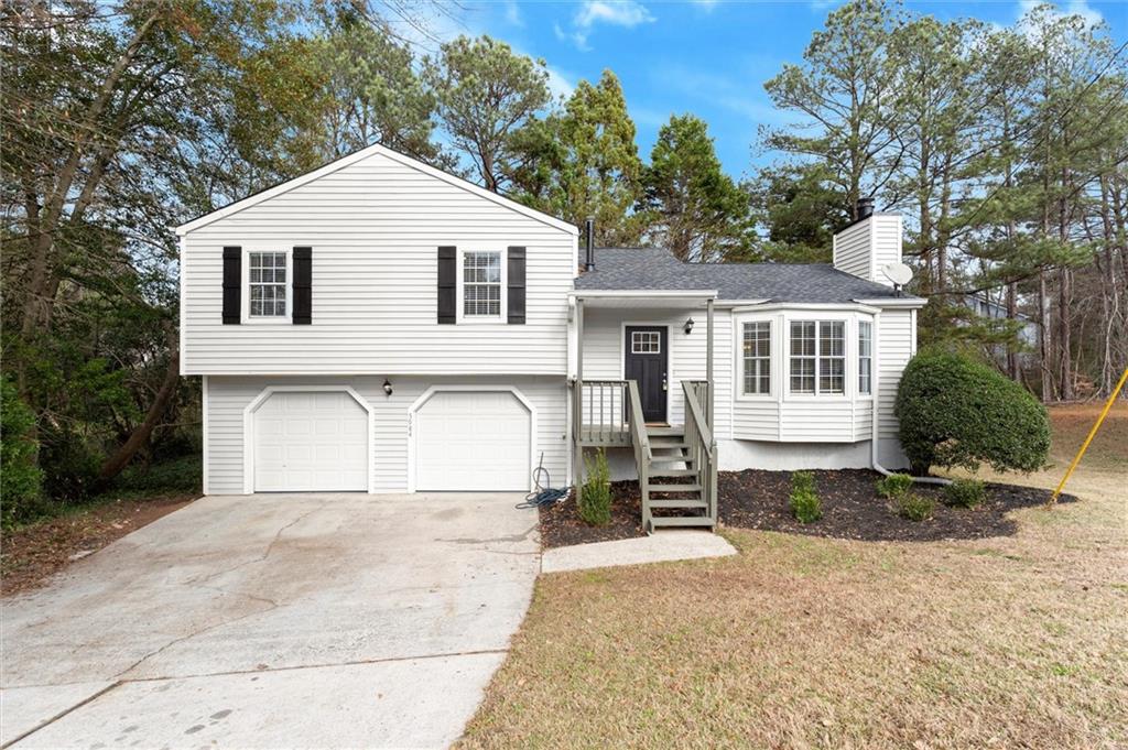 5984 Brookside Court Southeast Mableton, GA 30126 - Photo 20 of 21 a view of a white house with a yard and plants