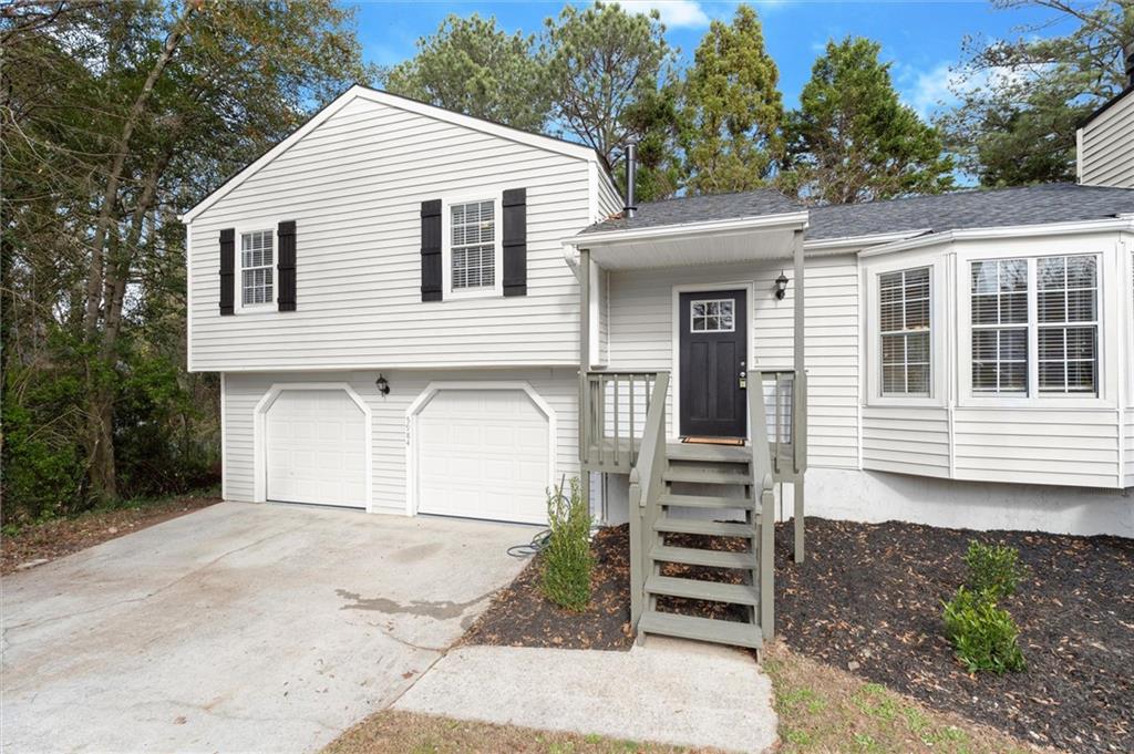 5984 Brookside Court Southeast Mableton, GA 30126 - Photo 21 of 21 a view of a house with a yard and garage